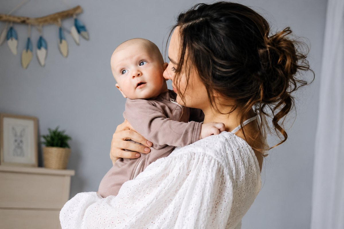 Mother gently holding her baby